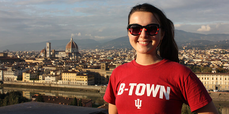 A student posing in front of the landscape during a Study abroad.